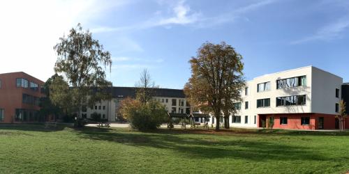Blick auf die TGS "Montessorischule" mit Grünanlage und Schulhof